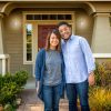 Stock photo of a young, attractive Asian American couple outside their home