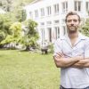 Portrait of mid adult man in front of house